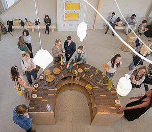 People standing around a table with food