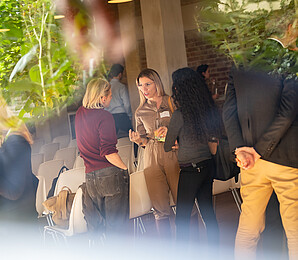 three women talking and networking