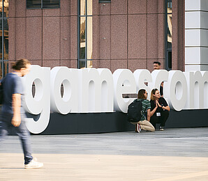 Gamescom sign with visitors