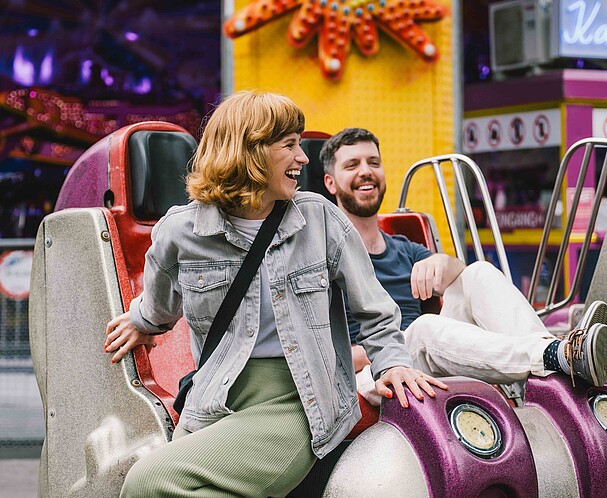 A man and a woman getting of a ride in the Wiener Prater funfair