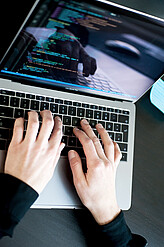 Working in tech in Vienna An image of two hands on a laptop keyboard, screen visible
