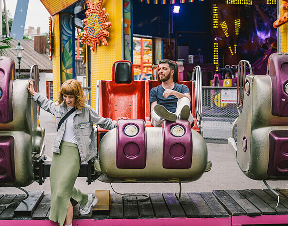 A woman and man on a fairgound ride in Vienna's Prater