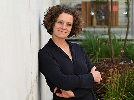 Woman leaning against a wall