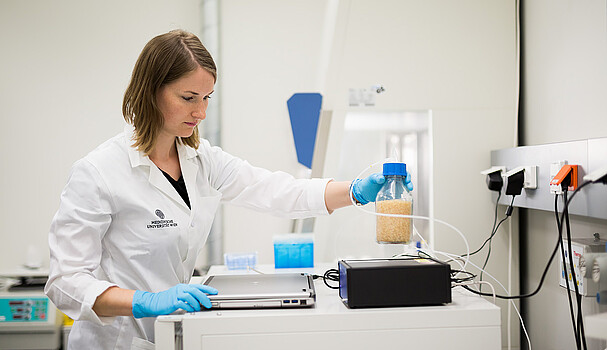 Female laboratory technician looking at a test tube