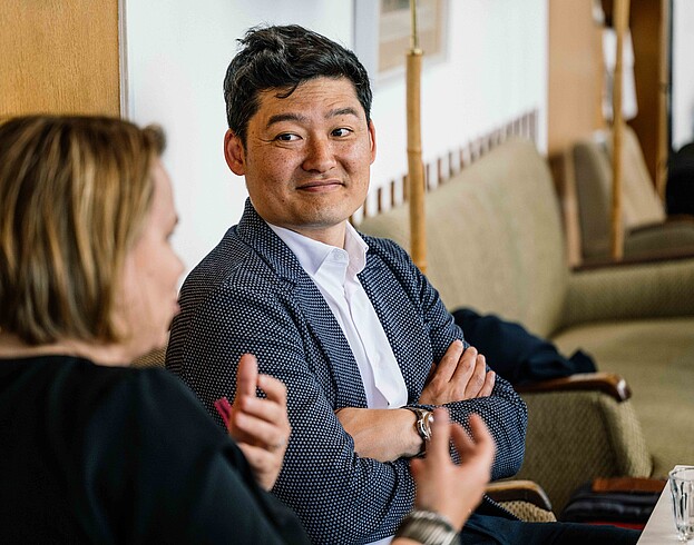 One woman and one man discussing indoors.