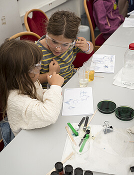 Two young girls using scientific equipment
