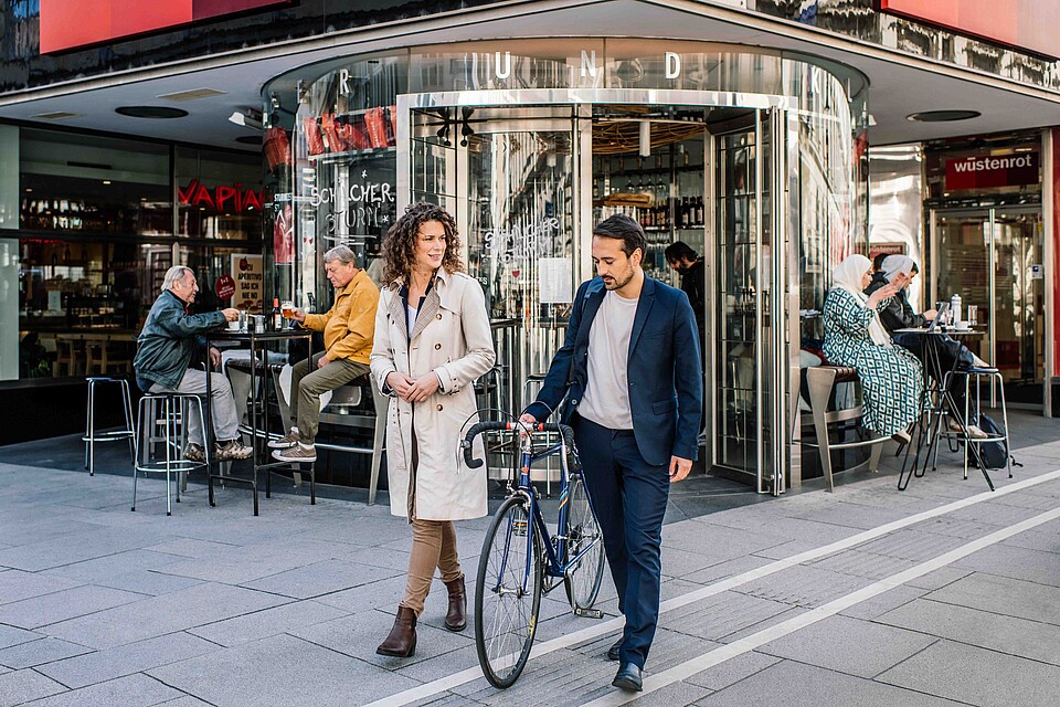 Woman and Man with bicycle on Vienna streets
