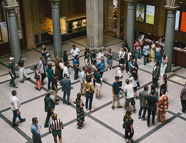 A gathering of people in a large foyer from above